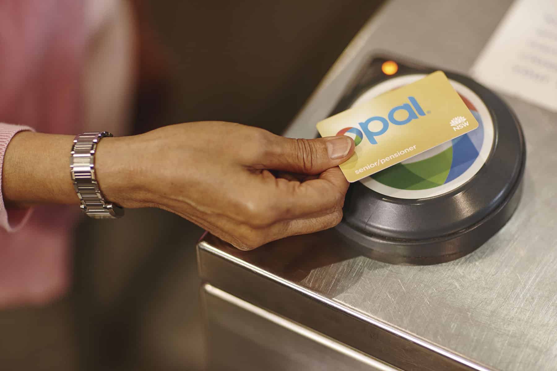 Hand holding an Opal card — Sydney Metro